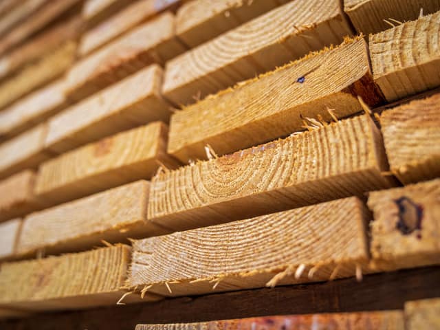 A close stack of sawn fence boards, end grain toward the camera.